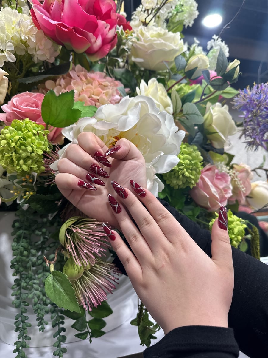 Glossy dark red burgundy almond nails at Blossom's Nails Boutique