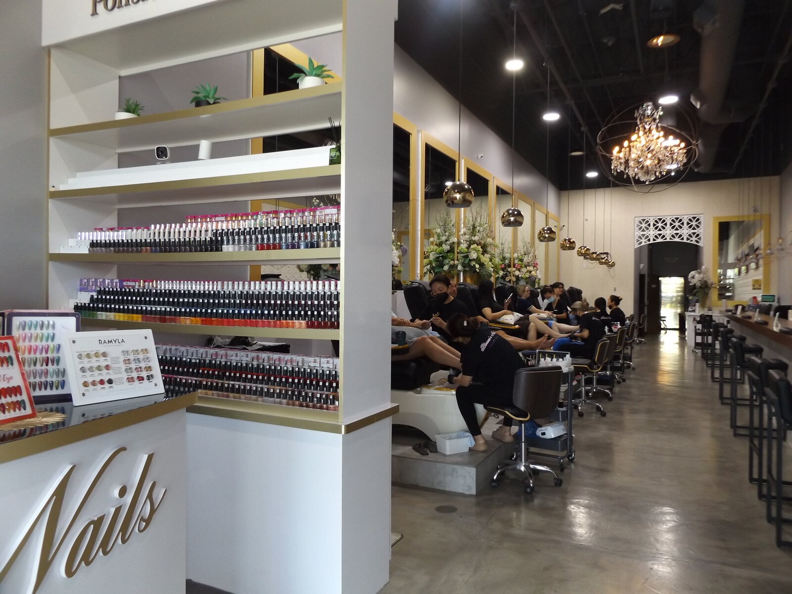 Gold Nails lettering and polish shelves at Blossom's Nails Boutique