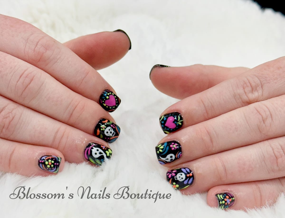 Black nails with colorful Day of the Dead sugar skull nail art at Blossom's Nails Boutique